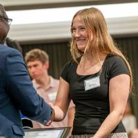 laura shaking hands with bayo